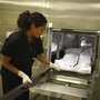 A morphology technician at   The New Mexico Office of the Medical Investigator stores one of the bodies that is autopsied there. The office was created by the state legislature in 1972 replacing the county coroner system.